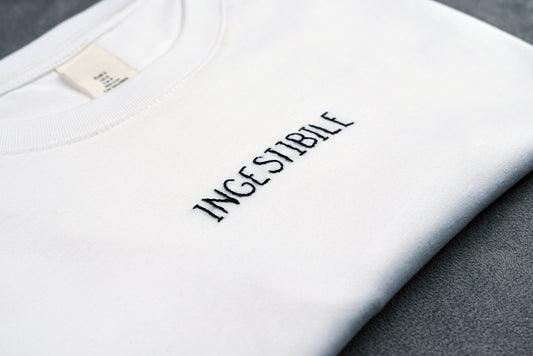 Dettaglio T-shirt “INGESTIBILE”, la maglietta in 100% cotone è ricamata con la scritta "ingestibile"